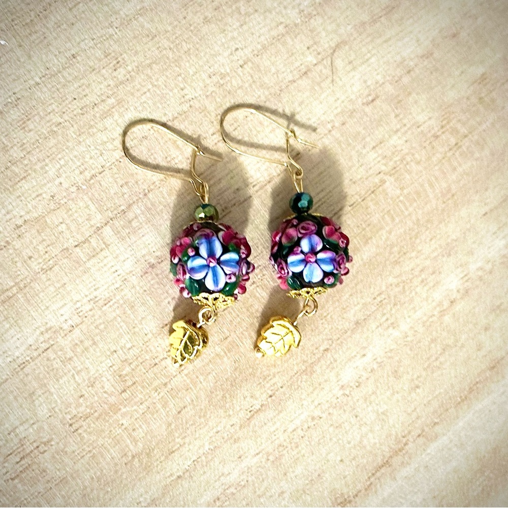 Flower lamp work beaded earrings with gold leaf dangles
